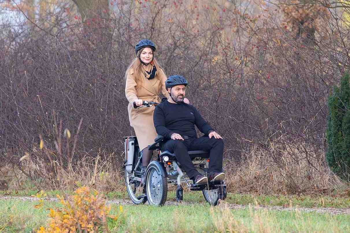 Bicycle with 2 wheels in the frond OPair wheelchairbike Van Raam